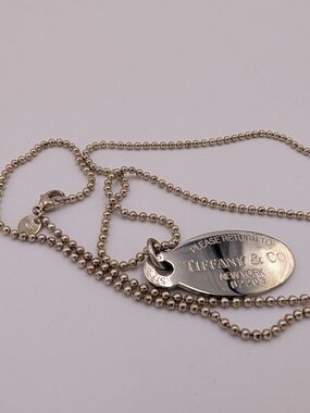 Tiffany & Co. polished silver oval tag on beaded chain